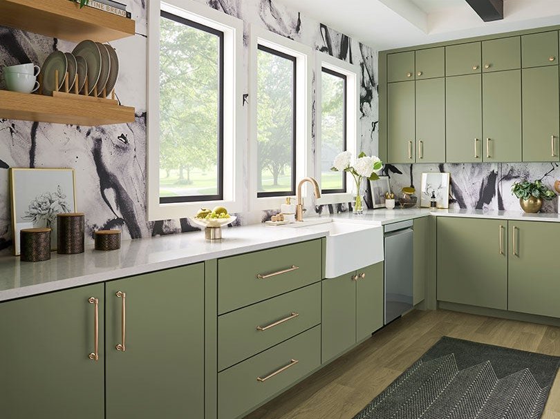 Brass Jeffrey Alexander bar pulls on sage green kitchen cabinets
