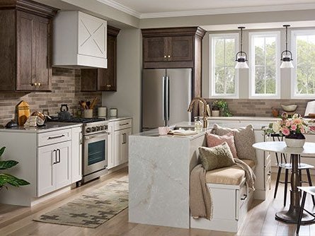 White kitchen with a marble island and Jeffrey Alexander hardware