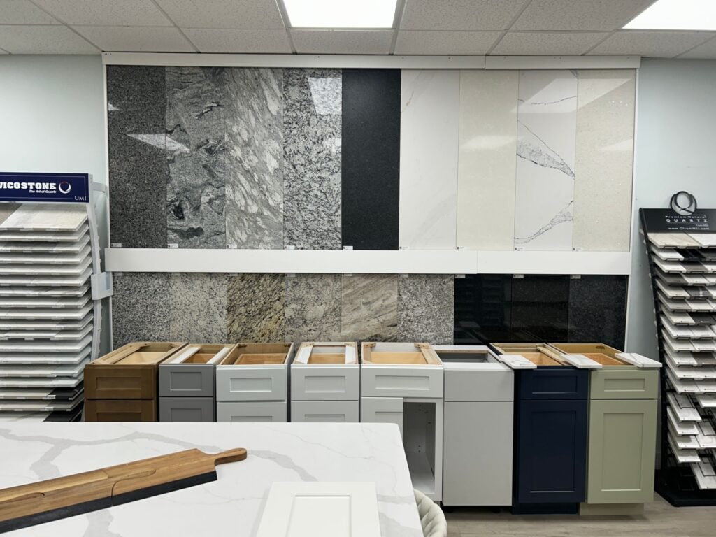 Granite and quartz sample wall with Vicostone quartz at Land of Cabinets