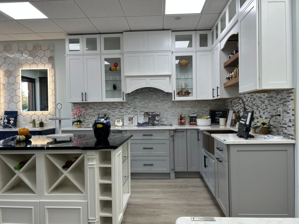 White and gray shaker kitchen display with glass-front uppers