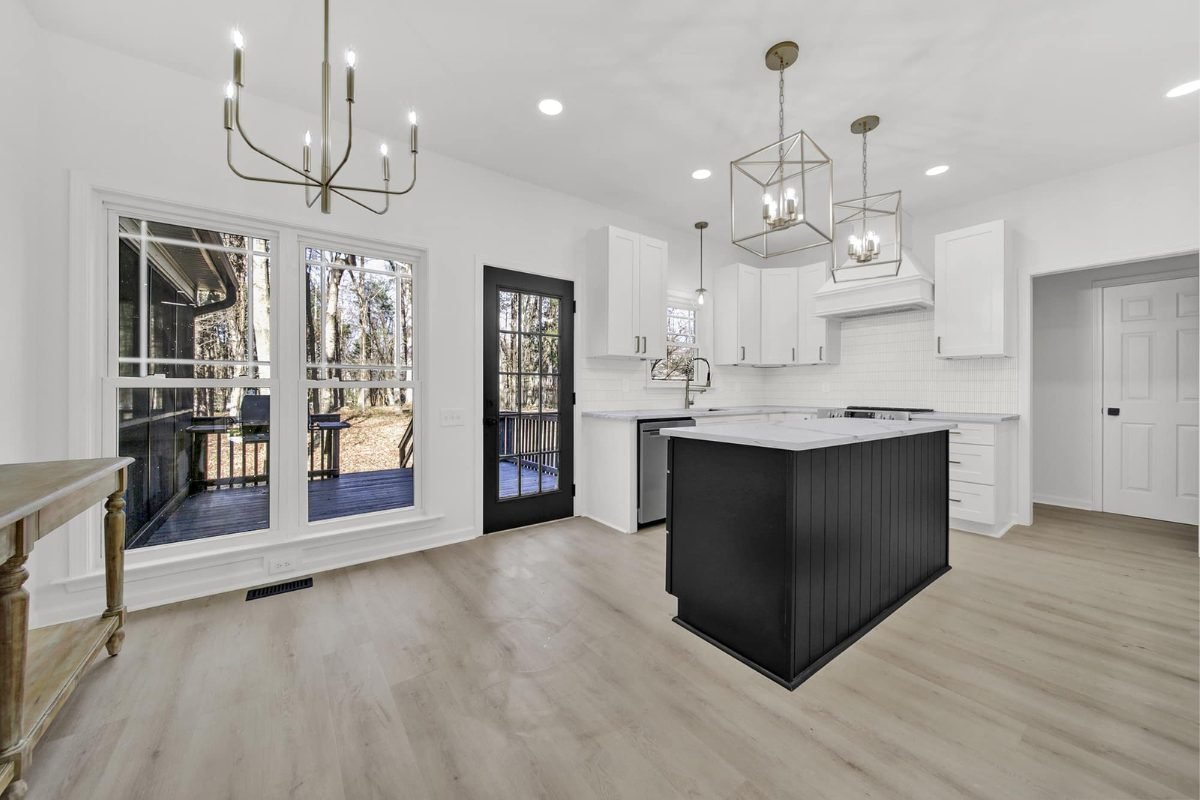 L and C Cabinetry D8 Black Swan kitchen with white cabinetry and black island