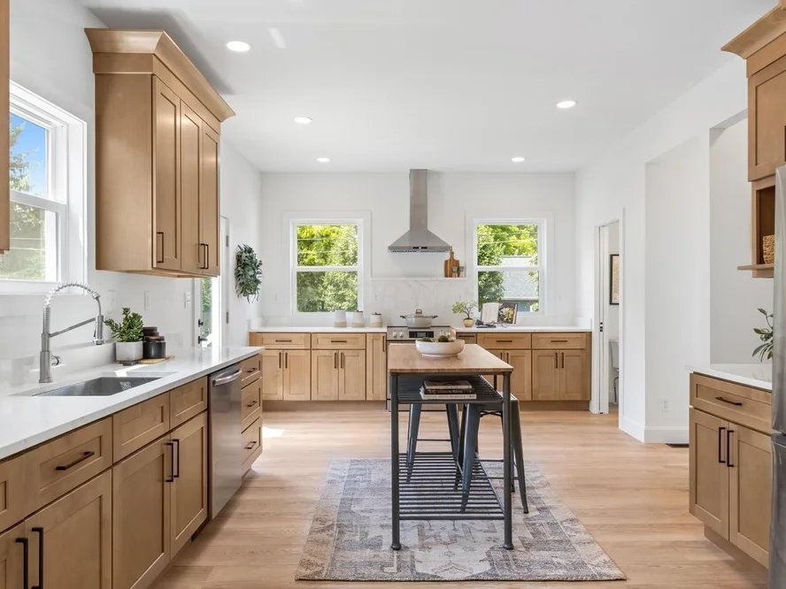 Timberpeak wood-tone shaker kitchen cabinets with white countertops
