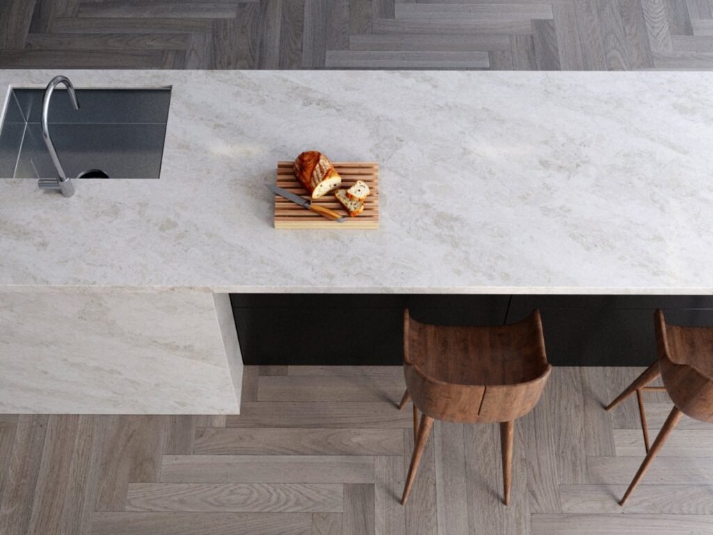 Vicostone Natural Collection quartz island with a sink and wood stools