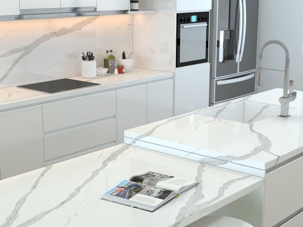 White veined Vicostone quartz countertop with a cooktop and waterfall edge